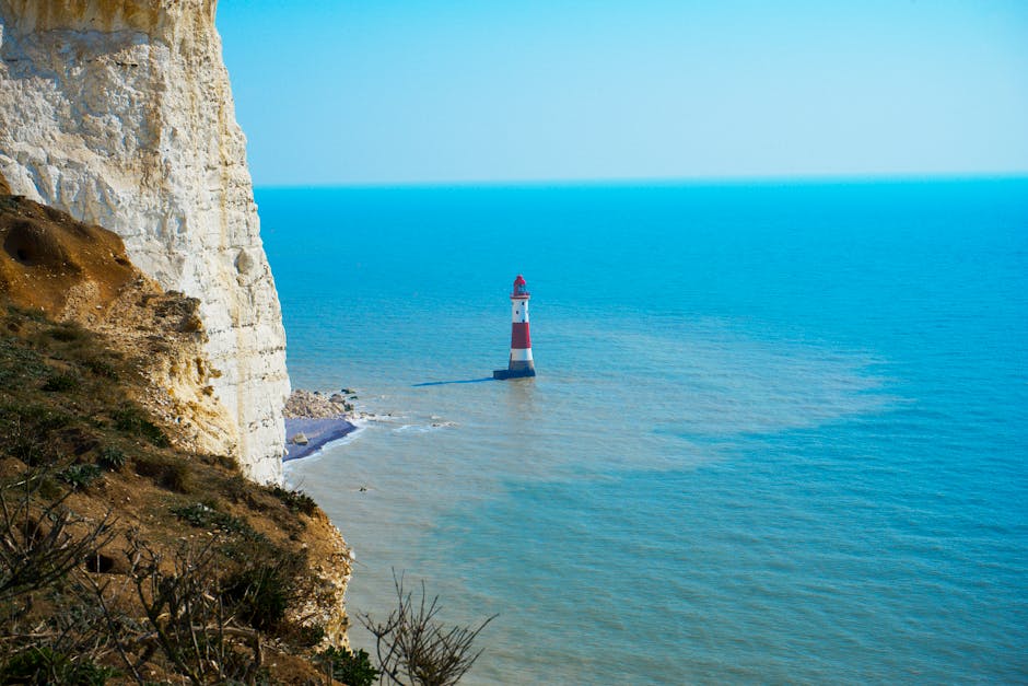 Dramatic coastal view of Beachy Head Lighthouse and cliffs near Eastbourne, UK.